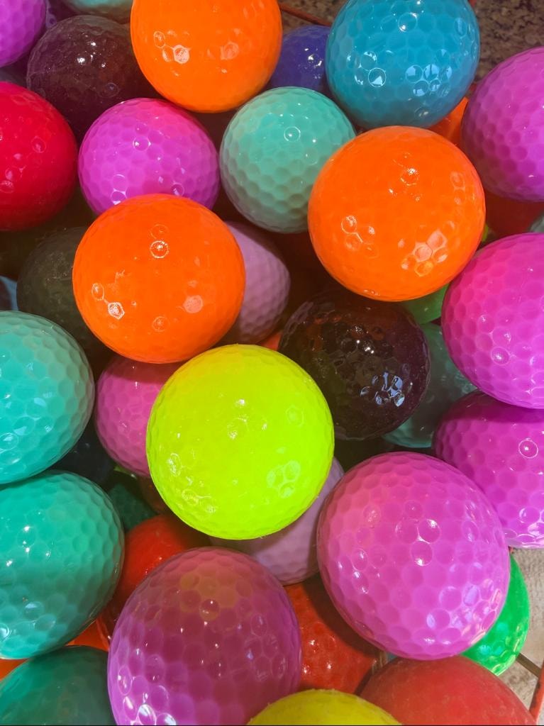 Colorful golf balls in vibrant hues at Golf Mountain Mini Golf